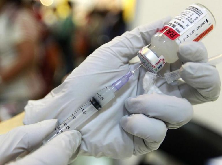 A veterinarian prepares a dosage of rabies vaccine at the 2014 Taipei Pet Show at Nangang Exhibition Hall in Taipei